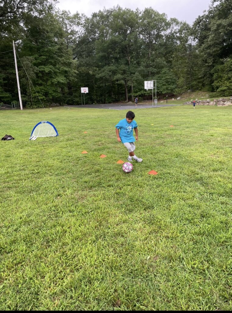 Yan Garcia, a Hillburn-based Soccer Coach trains a child of the Hillburn community.